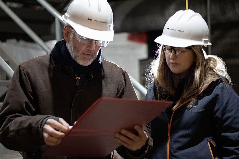 workers in hard hats reviewing paperwork photo
